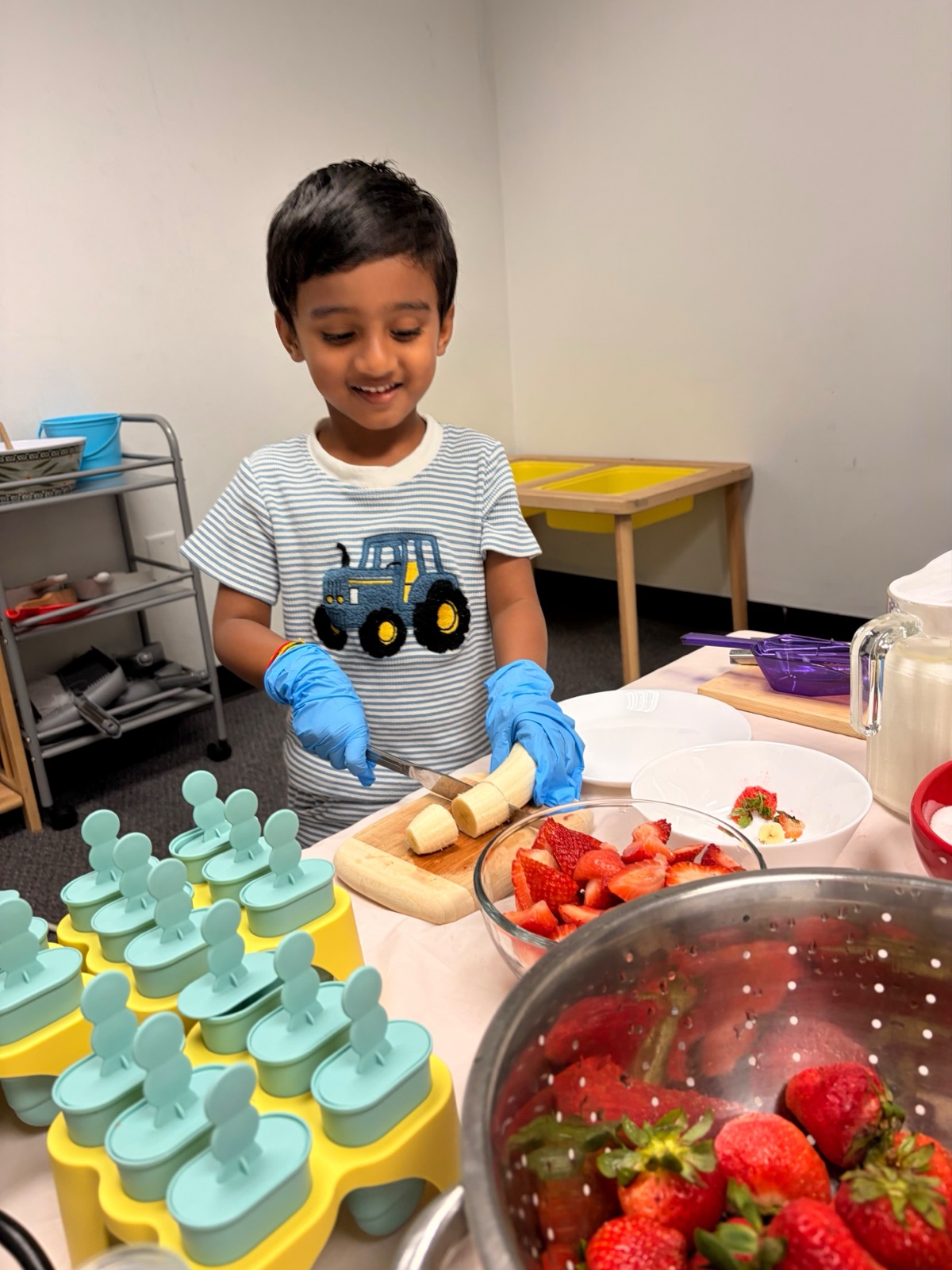 child slicing a banana for snack, practical life