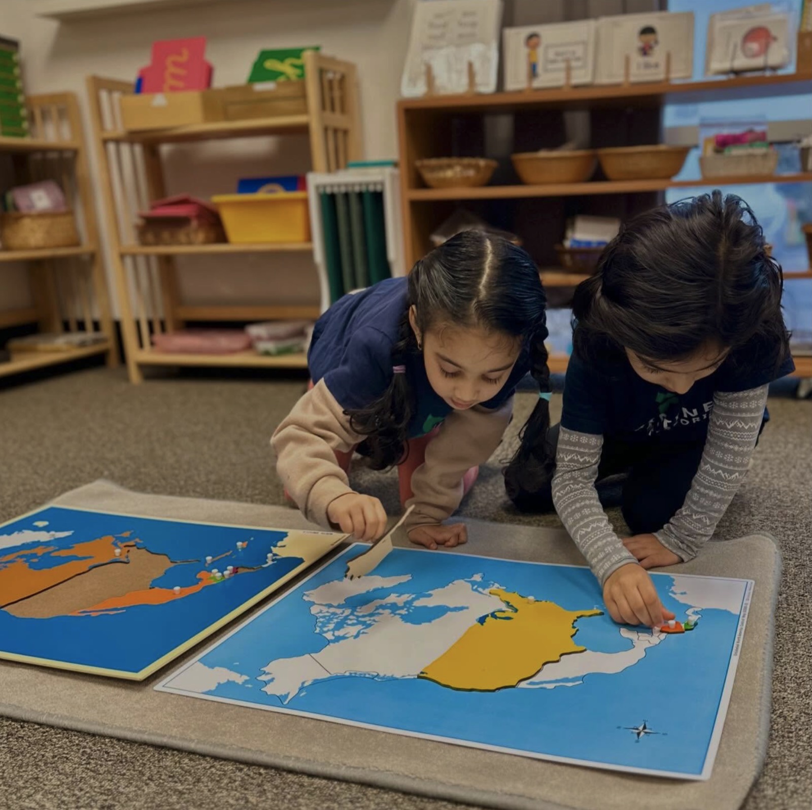 two children working together on the continent maps