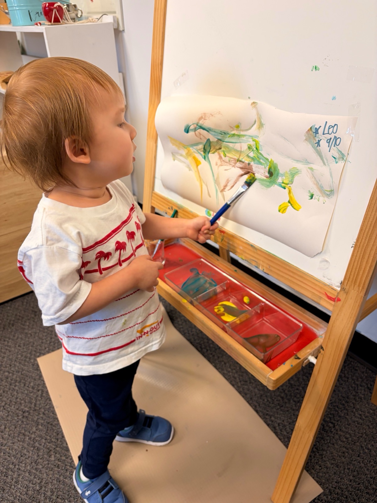 toddler painting at the easel